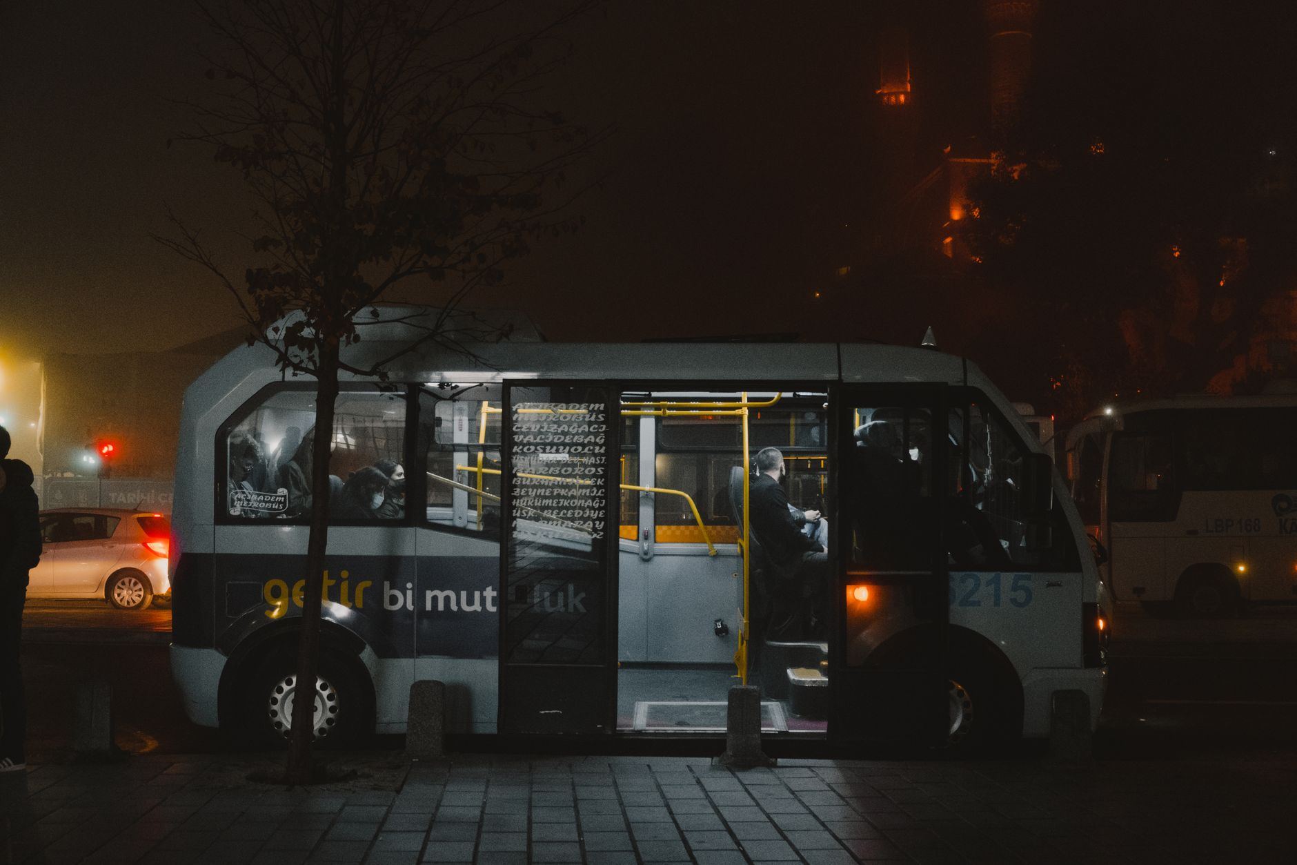 Ônibus de viagem estacionado à noite com luzes acesas